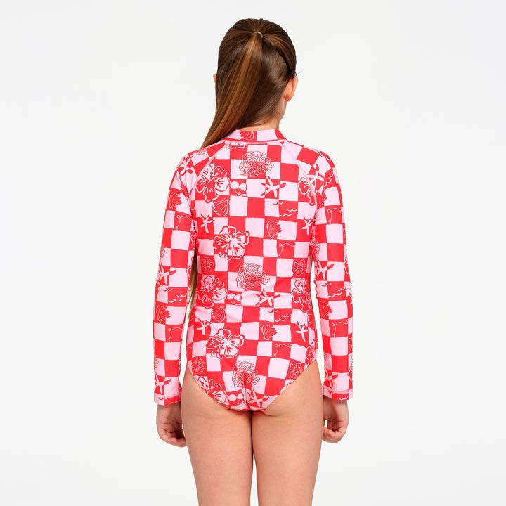 A girl viewed from the back wearing a red and white patterned long-sleeve swim leotard against a plain white background.