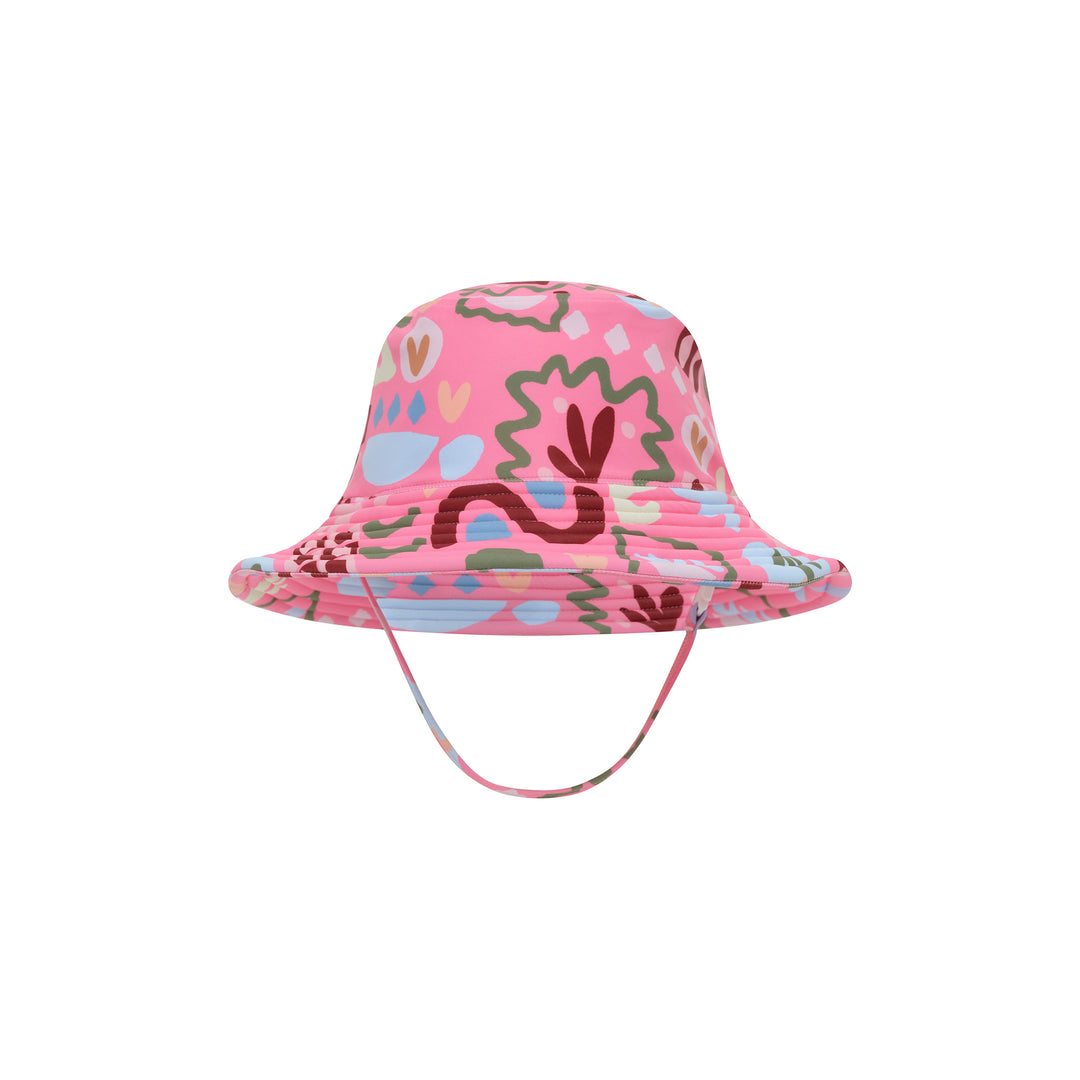 A pink bucket hat with a colorful abstract pattern of organic shapes, featuring a matching chin strap, shown against a plain white background.