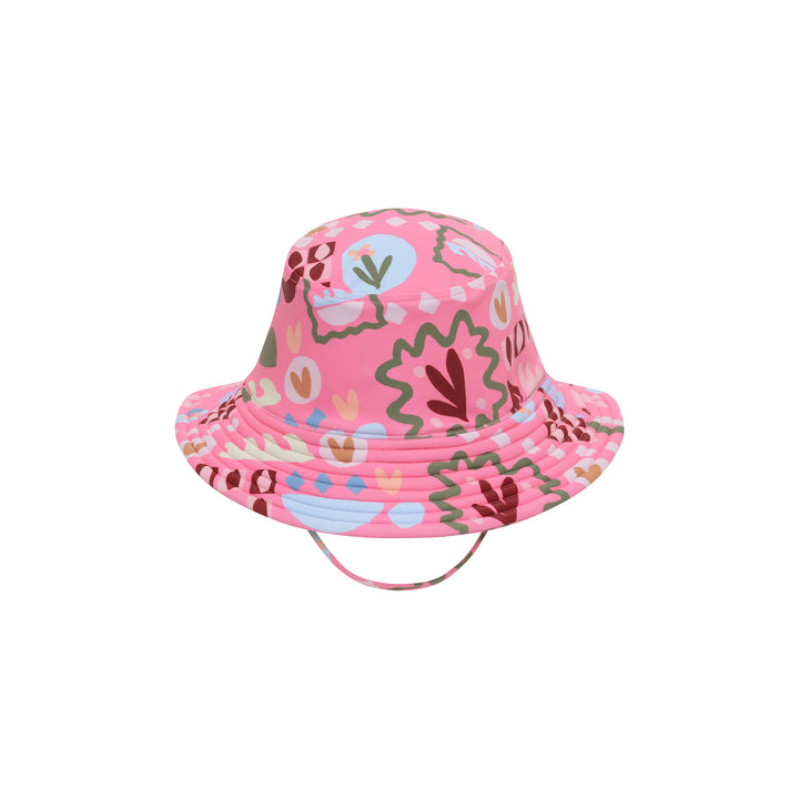 A pink bucket hat with a colorful abstract pattern of leaves, hearts, and geometric shapes, shown against a plain white background.