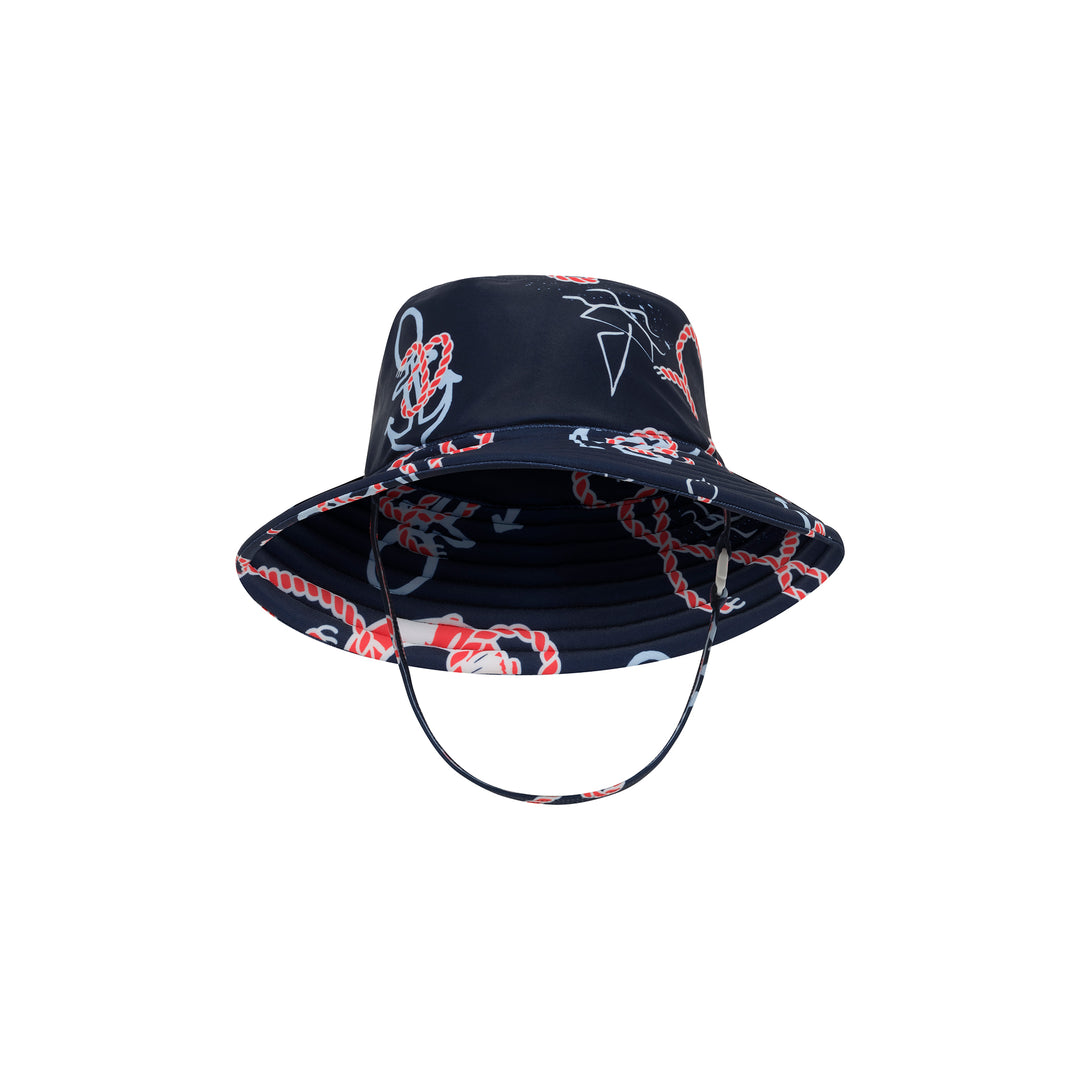 A navy blue bucket hat with a nautical print of red ropes, white anchors, and seagulls, featuring an adjustable chin strap, shown against a plain white background.