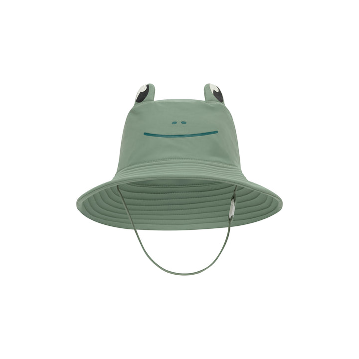 A sage green children's sun hat with a frog face design on the front and two raised frog ears with black and white accents. A thin chin strap hangs below the brim, photographed against a solid white background.