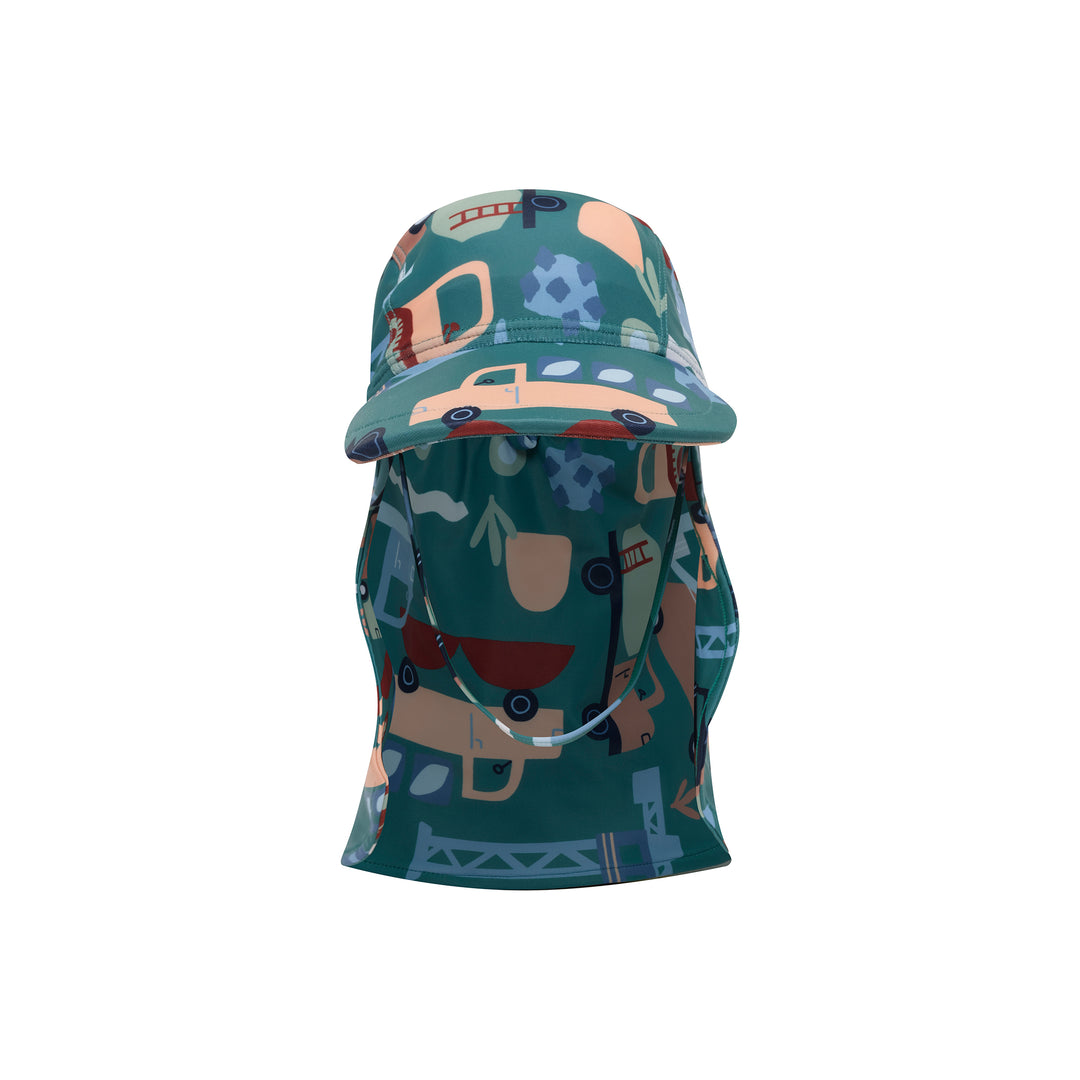A children's sun hat with an attached neck gaiter, featuring a teal green background with a playful pattern of construction vehicles, gears, and tools in shades of orange, blue, and brown.