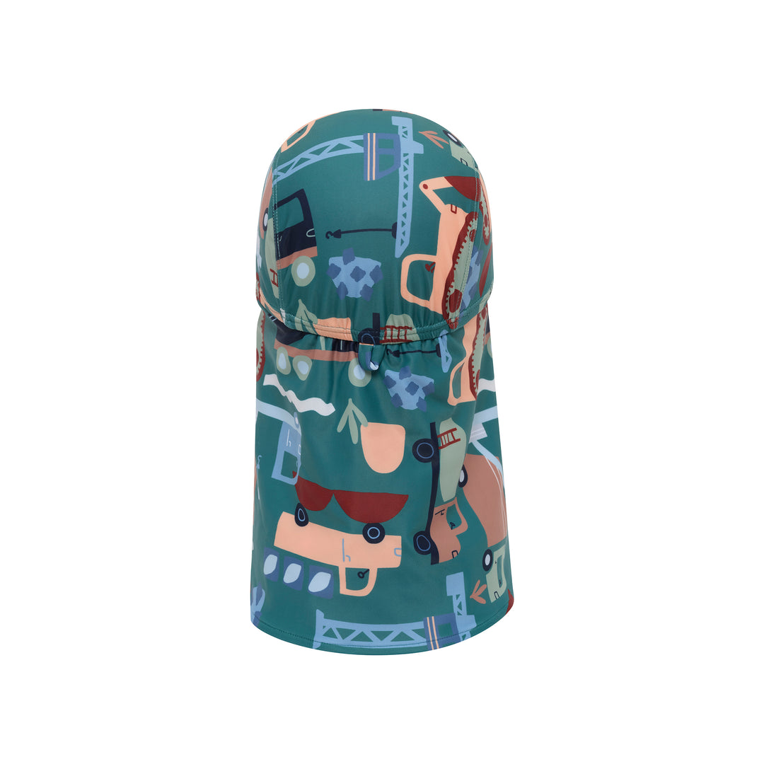 A teal children's sun hat with an attached neck gaiter, featuring a playful industrial and construction-themed print with cartoon cranes, excavators, and bridges in muted tones of beige, brown, and light blue.