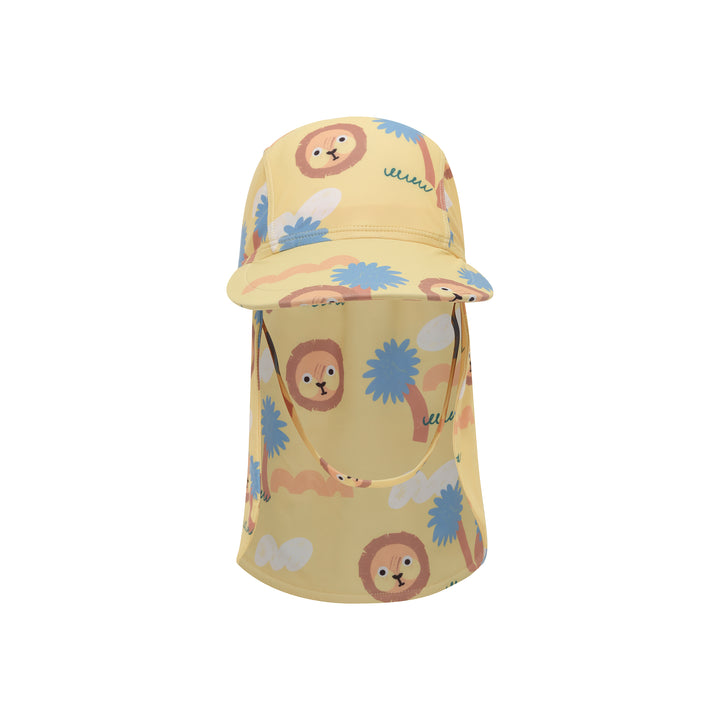 A yellow children's sun hat with an attached neck flap, featuring a playful print of cartoon lion faces, palm trees, and clouds in blue, brown, and green.