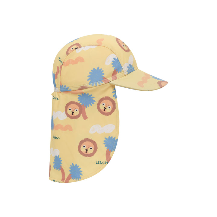 A children's sun hat with an attached neck flap, featuring a light yellow base color and a playful print of cartoon lions, palm trees, and clouds in blue, brown, and white.
