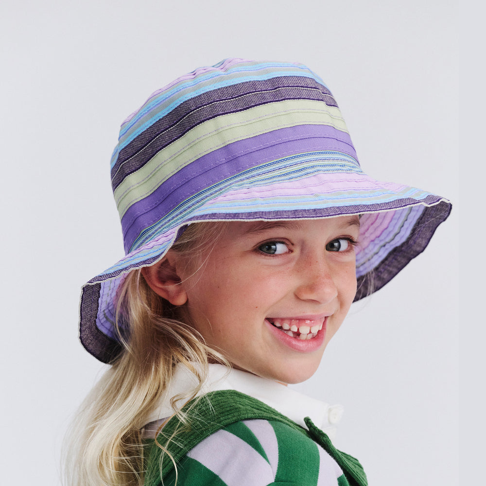 Quarter profile of kid model wearing Chloe bucket hat in Lilac