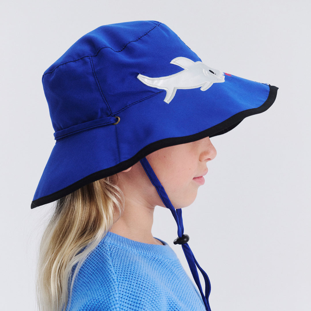 Side profile of model wearing Awesome wide brim hat in Blue Shark
