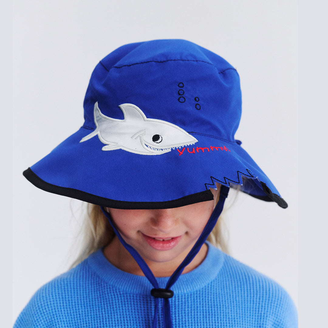 Model wearing Awesome wide brim hat in Blue Shark facing down to show brim detail