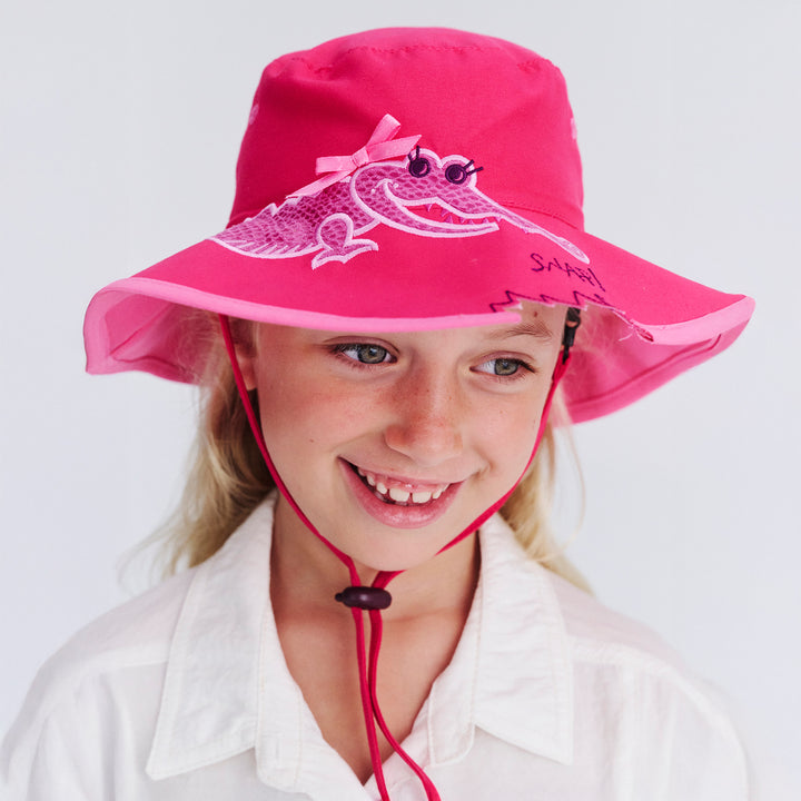 Child model wearing Awesome wide brim hat in Pink Croc, front‑facing view, looking down
