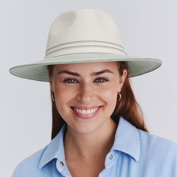 Female model wearing Heritage Town and Country Hat in ivory and sage colour, front view styled with blue top