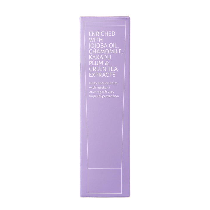 Purple sunscreen box from side, highlighting ingredients Jojoba oil, chamomile, kakadu plum and green tea