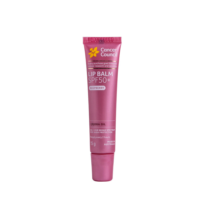 A tube of Cancer Council Lip Balm SPF50+ Raspberry lip balm, featuring a metallic pink packaging with a yellow logo and white text, set against a plain white background.