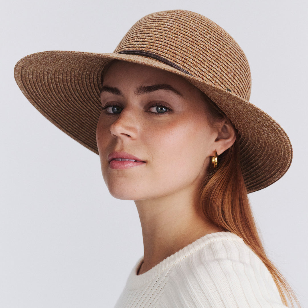 Female model wearing Maribel Cloche Hat in Cinnamon colour, three-quarter angle highlighting shape and silhouette