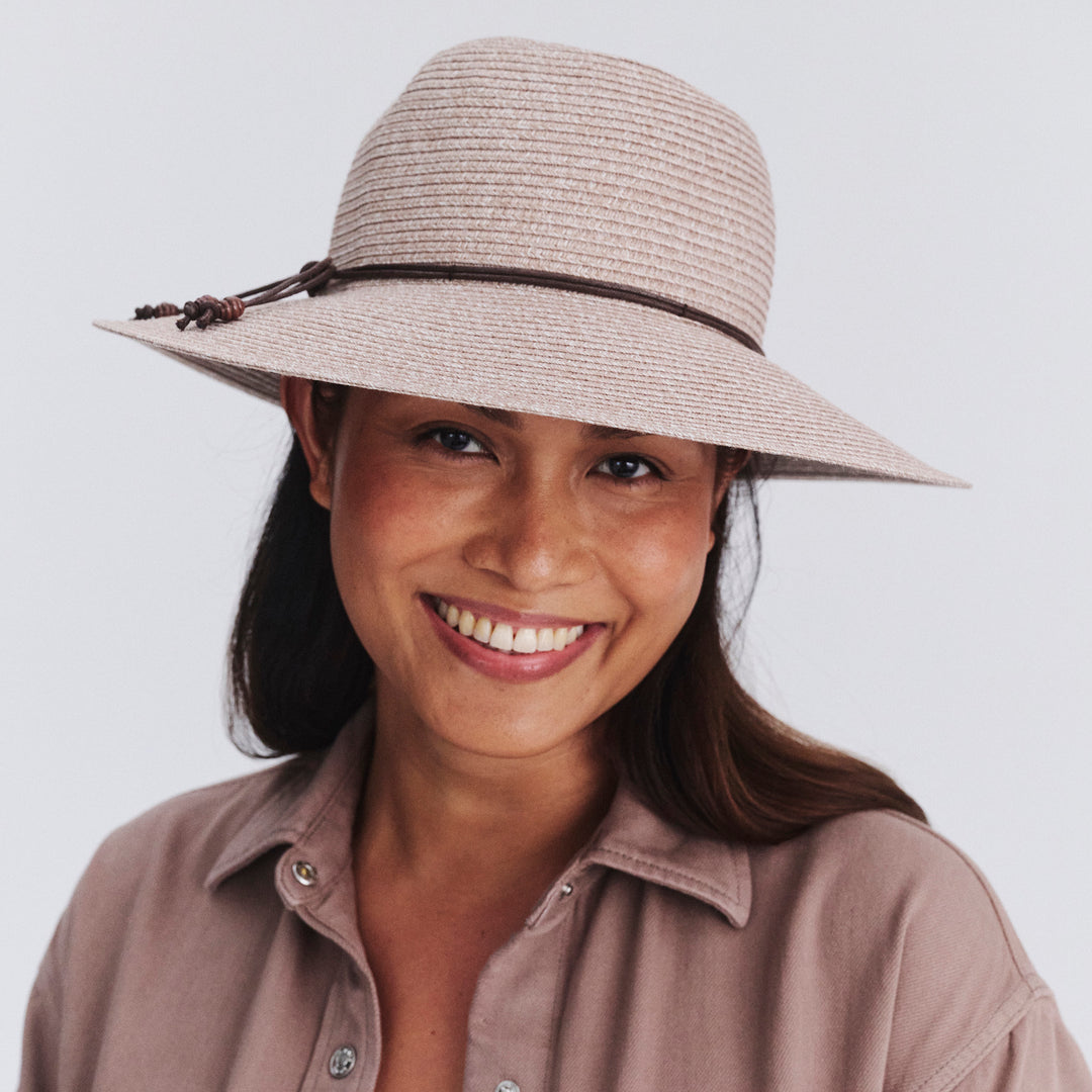 Female model wearing Maribel Cloche Hat in Sandstone colour, front view showcasing fit and wide brim