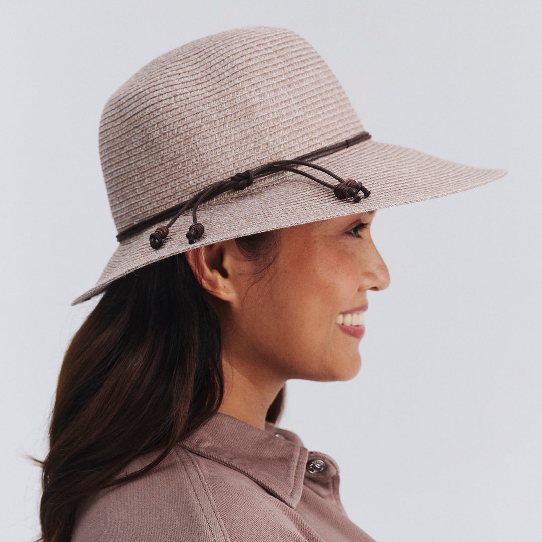 Female model wearing Maribel Cloche Hat in Sandstone colour, side profile showing brim coverage