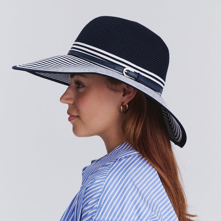 Female model wearing Amy Striped Capeline Hat in Navy/White colour, side profile showing brim coverage