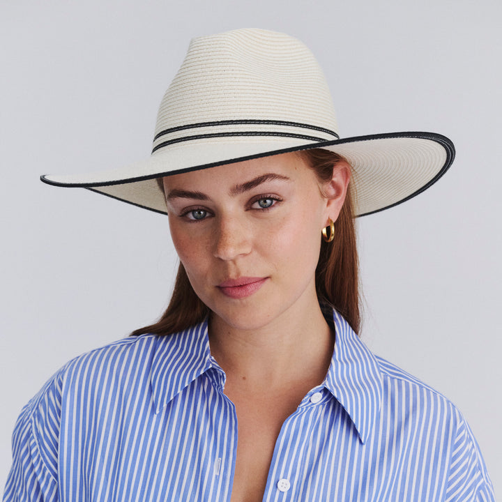 Female model wearing Liza Wide Brim Fedora Hat in Ivory/Black colour, front view showcasing fit and wide brim