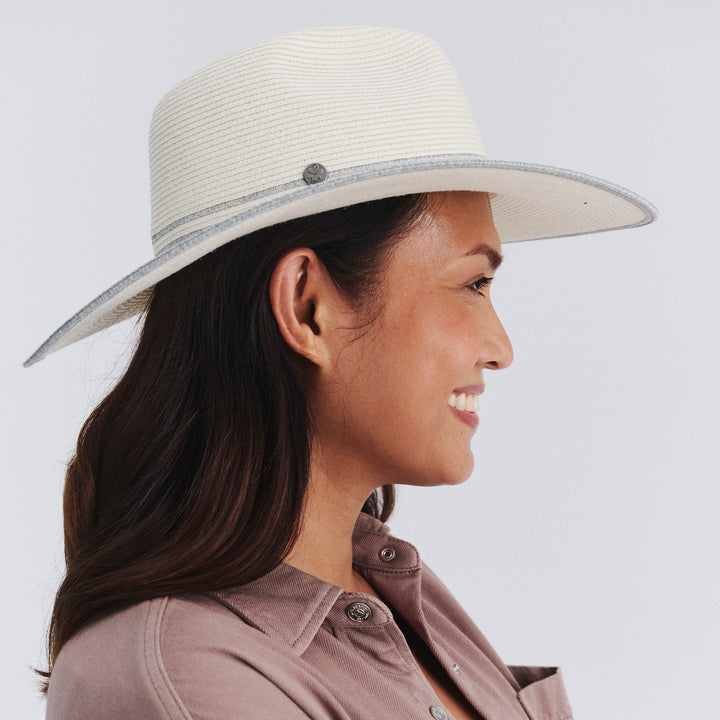 Female model wearing Liza Wide Brim Fedora Hat in Ivory/Light Blue colour, side profile showing brim coverage