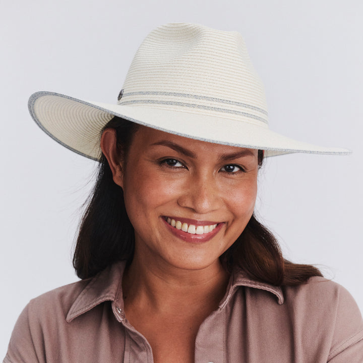 Female model wearing Liza Wide Brim Fedora Hat in Ivory/Light Blue colour, front view showcasing fit and wide brim