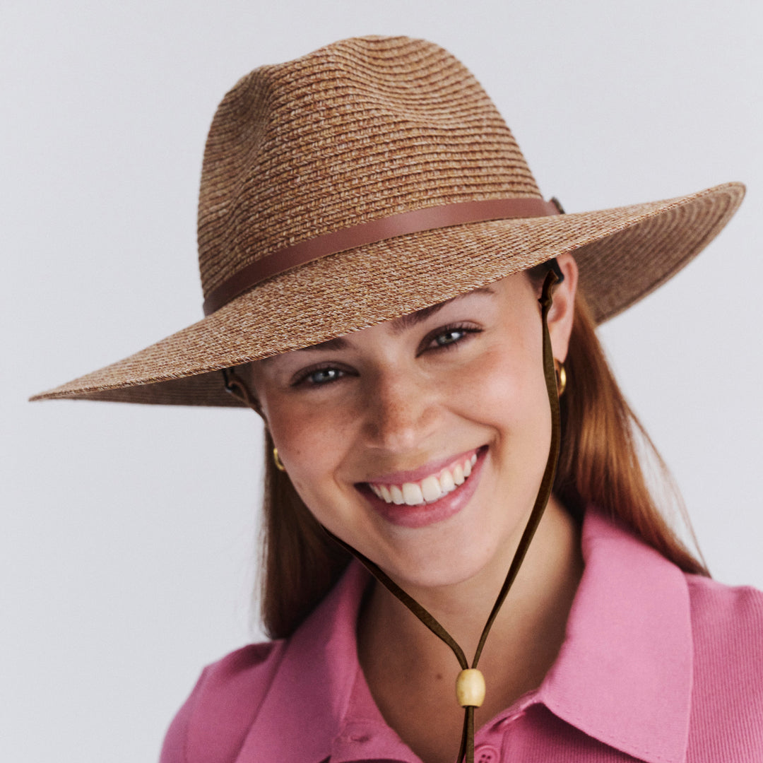 Female model wearing Mitzi Wide Brim Fedora Hat in Cinnamon colour, three-quarter angle highlighting shape and silhouette