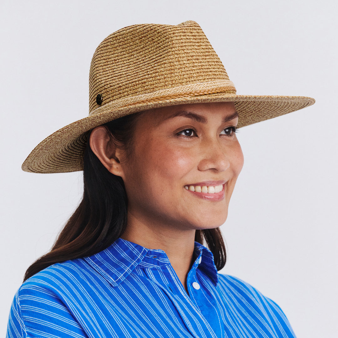 Female model wearing Roxy Wide Brim Fedora Hat in Camel colour, three-quarter angle highlighting shape and silhouette