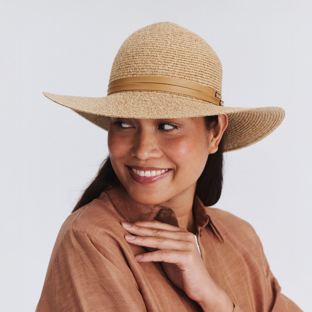Female model wearing Gena Capeline Hat in camel colour, front view showcasing fit and sun-protective wide brim