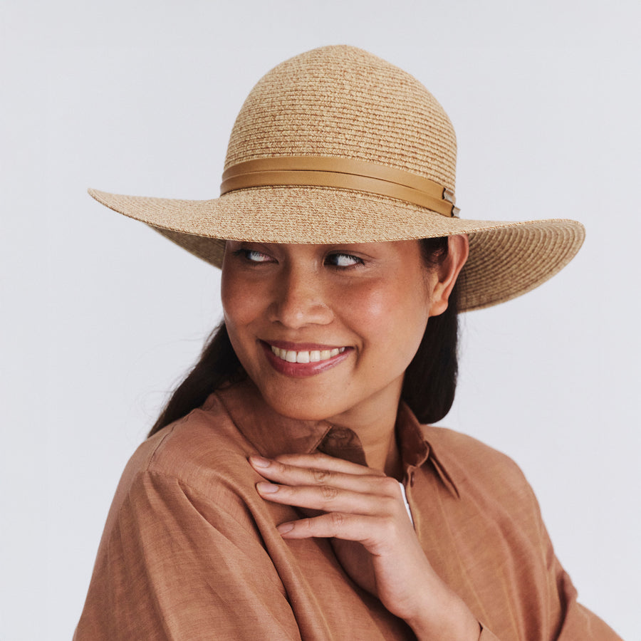 Female model wearing Gena Capeline Hat in camel colour, front view showcasing fit and sun-protective wide brim
