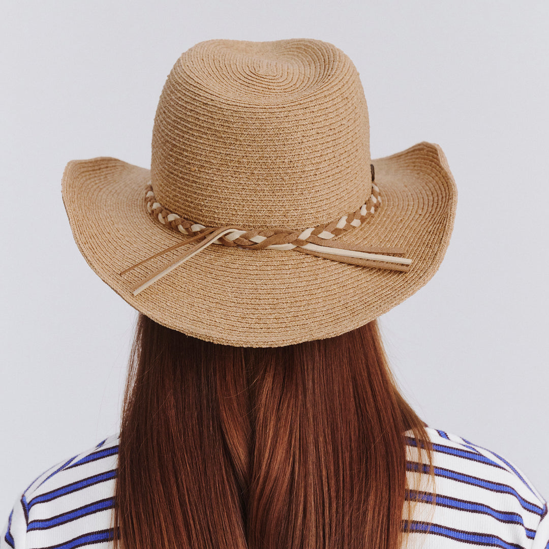 Female model wearing Jesse Raffia Cowboy Hat in natural colour, back view showing crown shape and fit