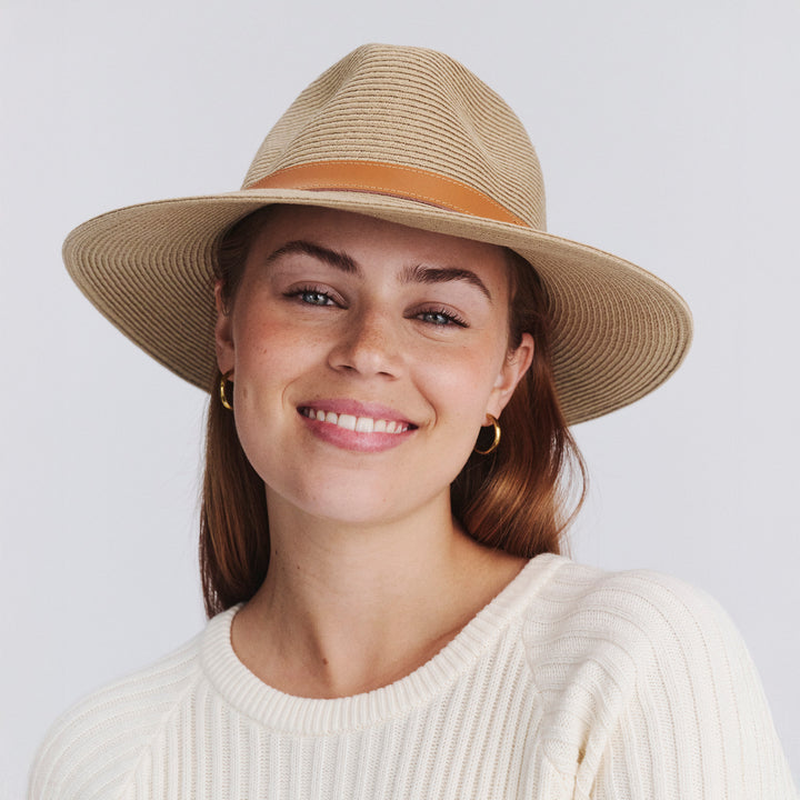 Female model wearing Morgan Fedora Hat in latte colour, front view styled with white outfit