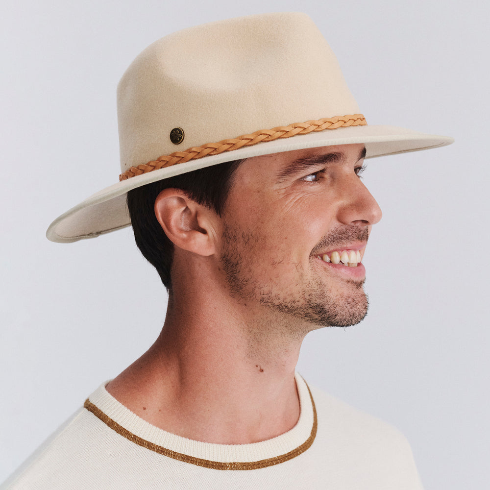 Male model wearing Bartle Fedora Hat in beige colour, three-quarter angle highlighting shape and fit