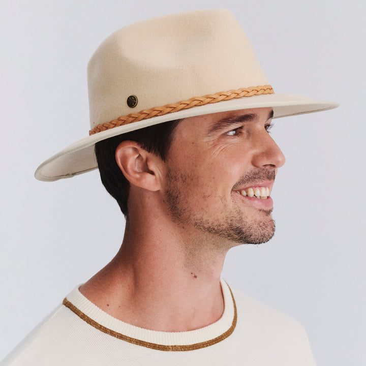 Male model wearing Bartle Fedora Hat in beige colour, three-quarter angle highlighting shape and fit