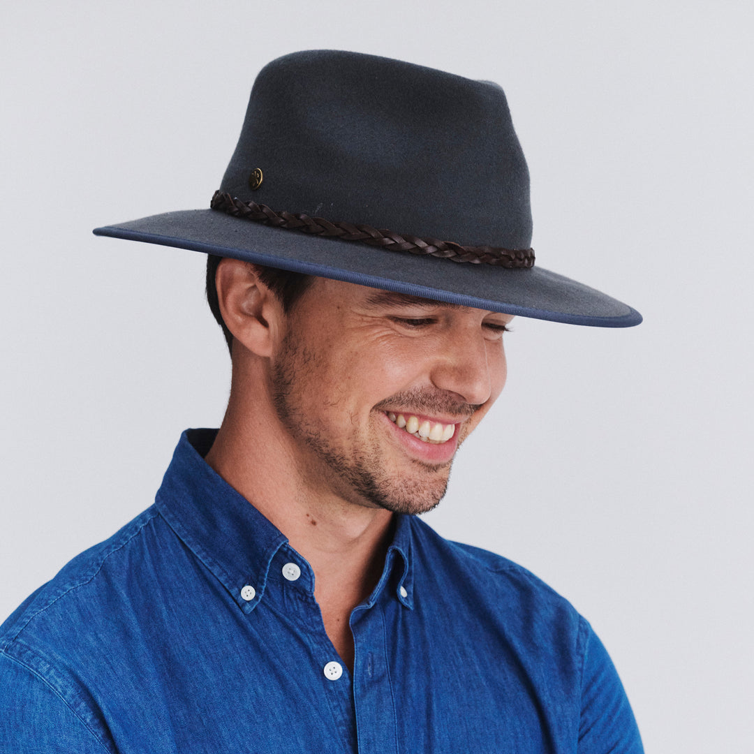 Male model wearing Bartle Fedora Hat in grey colour, three-quarter angle highlighting shape and fit