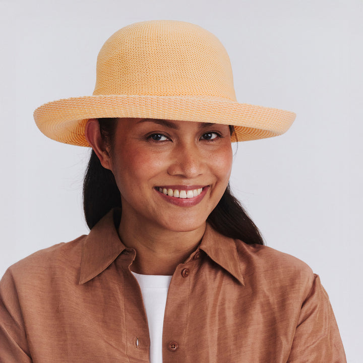 Female model wearing Classic Breton Hat in Apricot colour, front view showcasing fit and wide brim