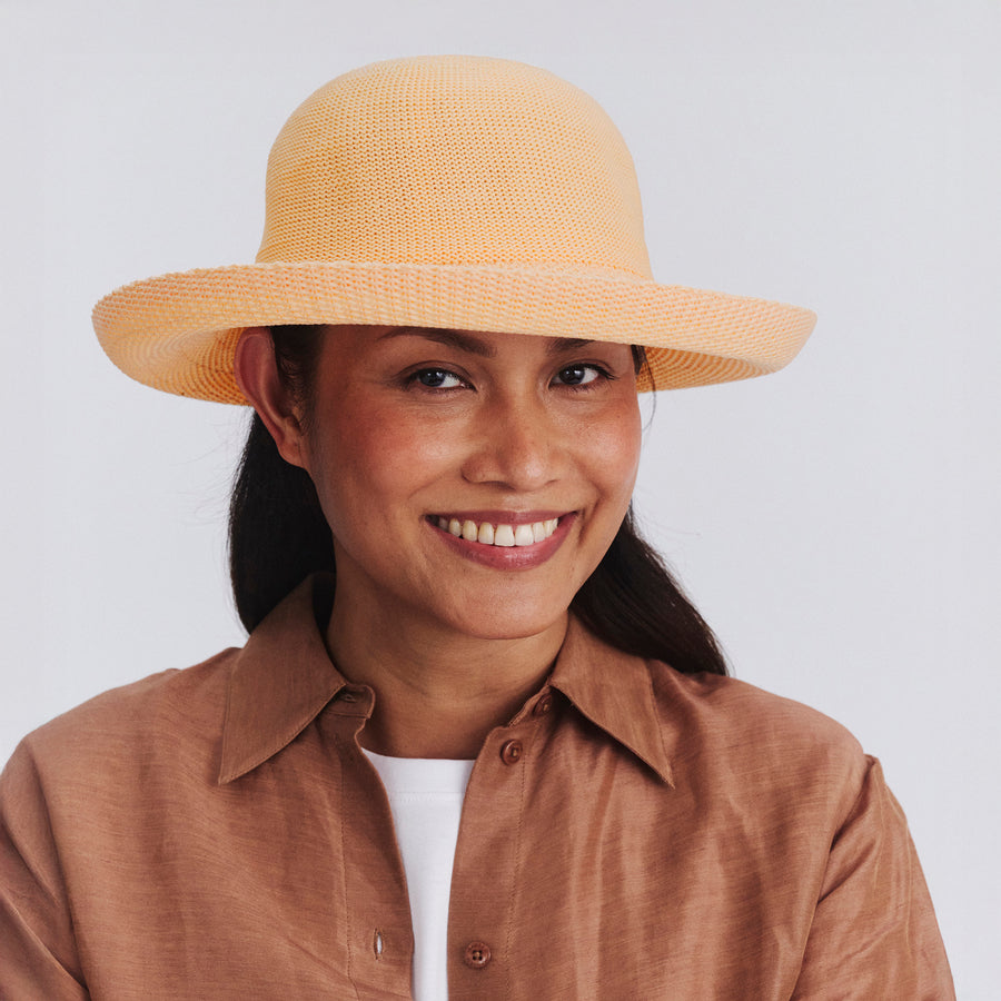 Female model wearing Classic Breton Hat in Apricot colour, front view showcasing fit and wide brim