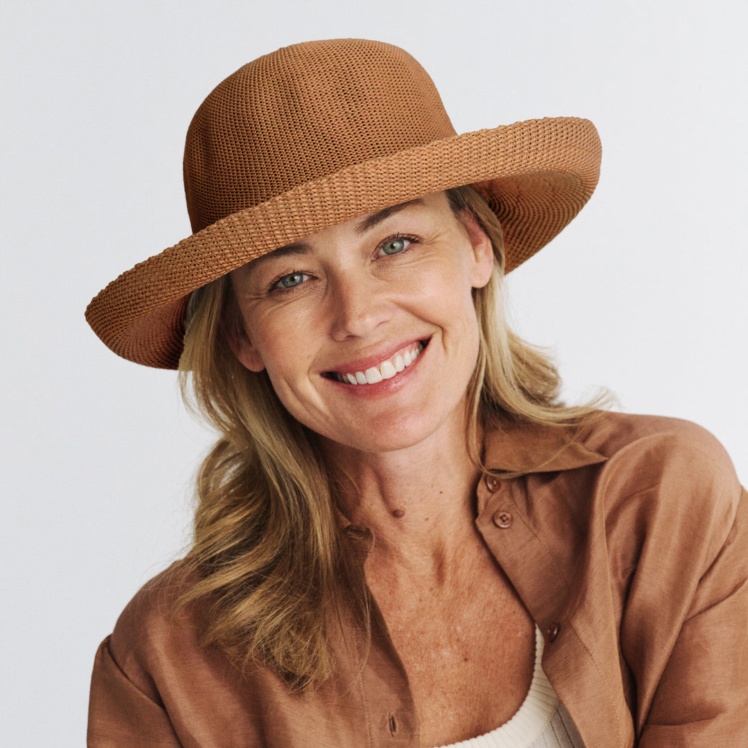 Female model wearing Classic Breton Hat in biscuit colour, front view styled with modern outfit