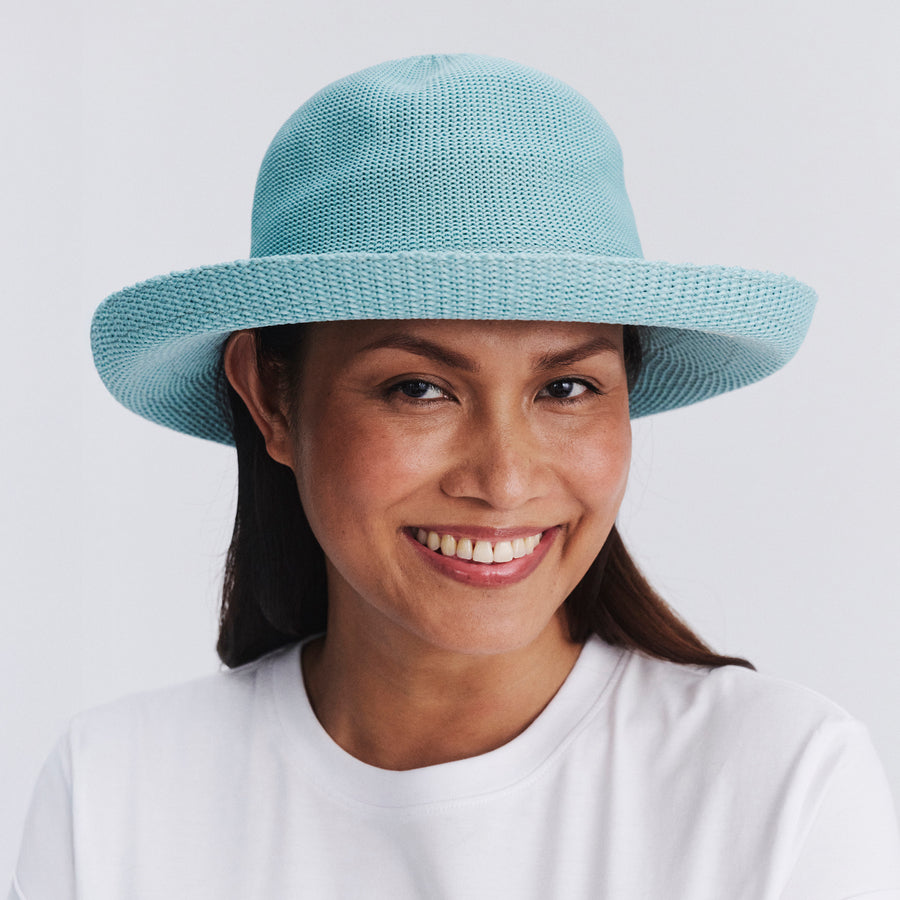 Female model wearing Classic Breton Hat in blue haze colour, front view styled with white shirt