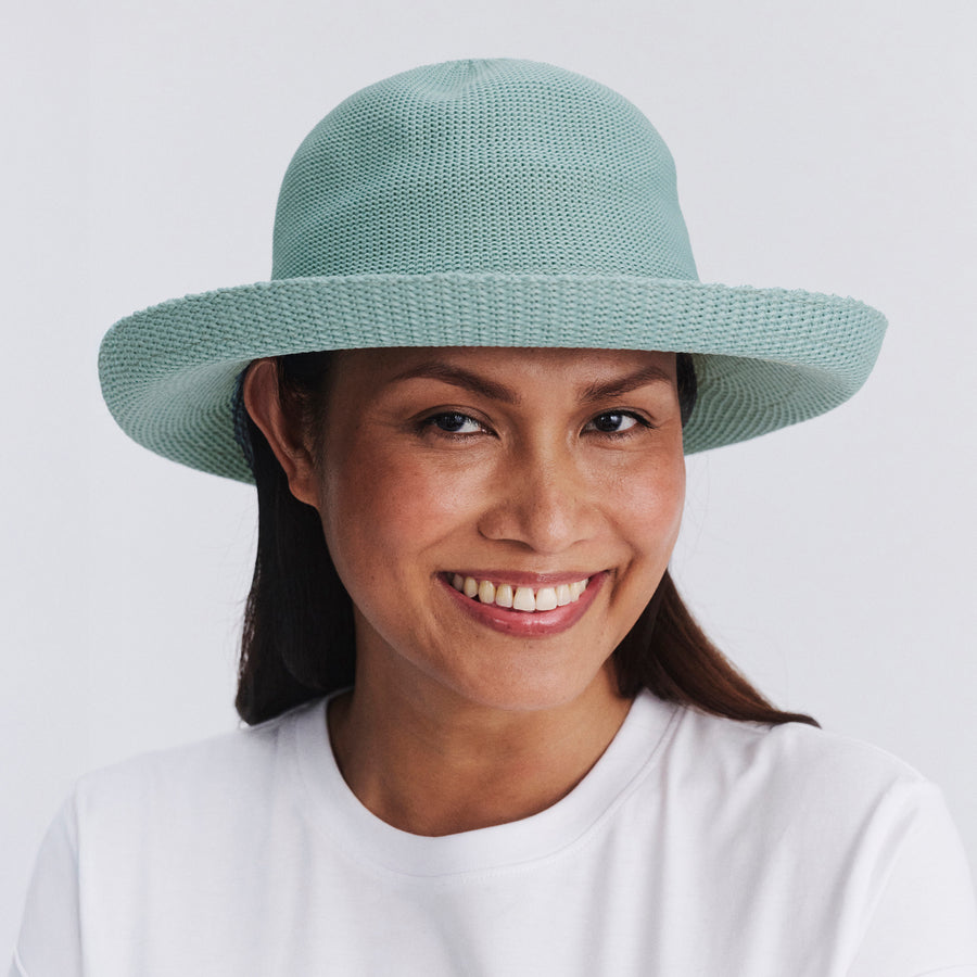 Female model wearing Classic Breton Hat in blue haze colour, front view styled with white shirt