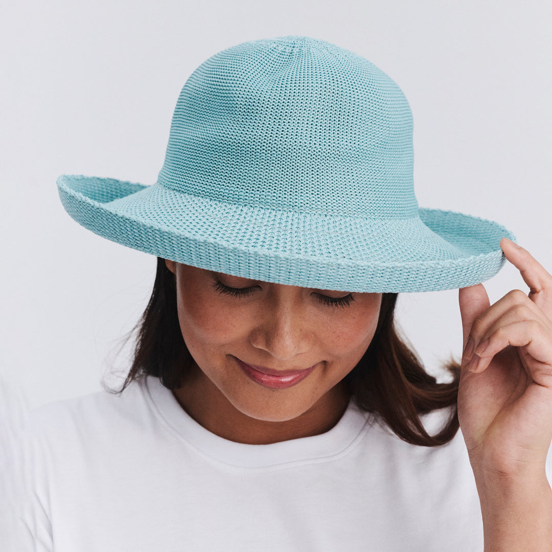 Female model wearing Classic Breton Hat in blue haze colour, front view with brim tipped down