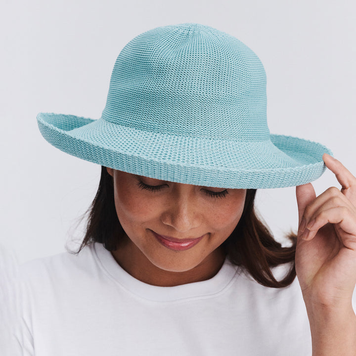 Female model wearing Classic Breton Hat in blue haze colour, front view with brim tipped down