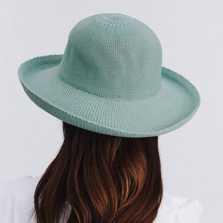 Female model wearing Classic Breton Hat in blue haze colour, rear view showing coverage