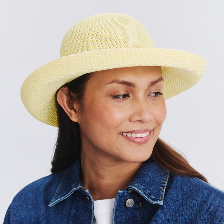 Female model wearing Classic Breton Hat in Lemon colour, three-quarter angle highlighting shape and silhouette