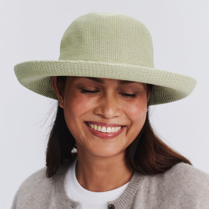 Female model wearing Classic Breton Hat in light moss green colour, eyes closed