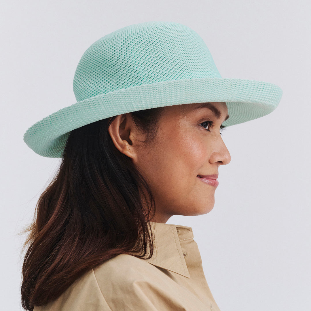 Female model wearing Classic Breton Hat in mint blue colour, side profile showing wide brim coverage and refined style