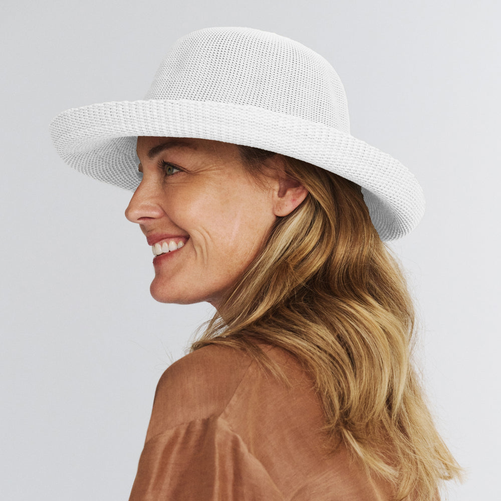 Female model wearing Classic Breton Hat in white colour, side profile showing wide brim coverage and refined style