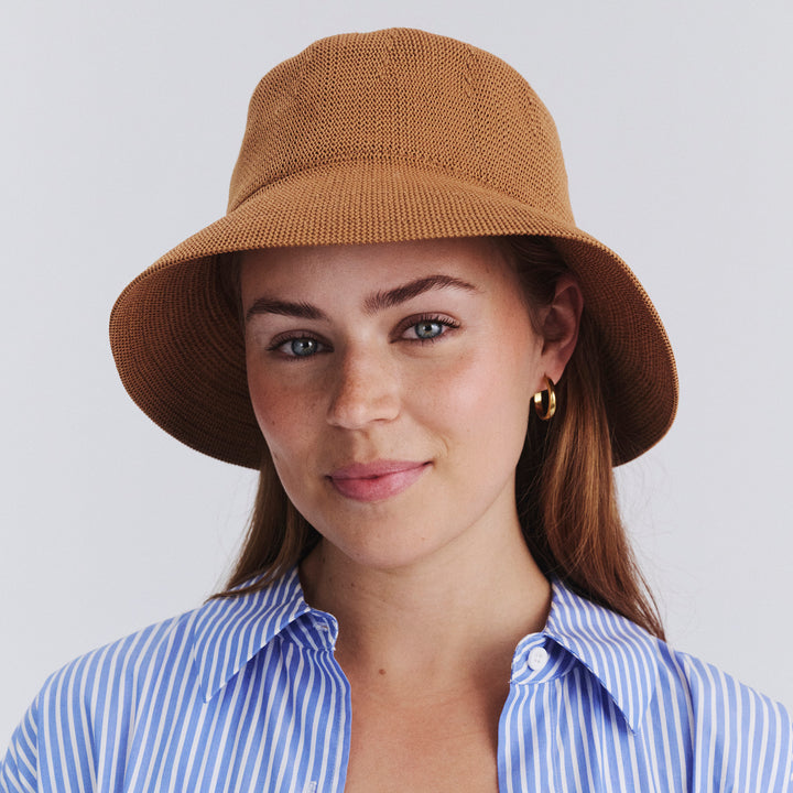 Female model wearing Tamzin Bucket Hat in biscuit colour, front view styled with casual outfit