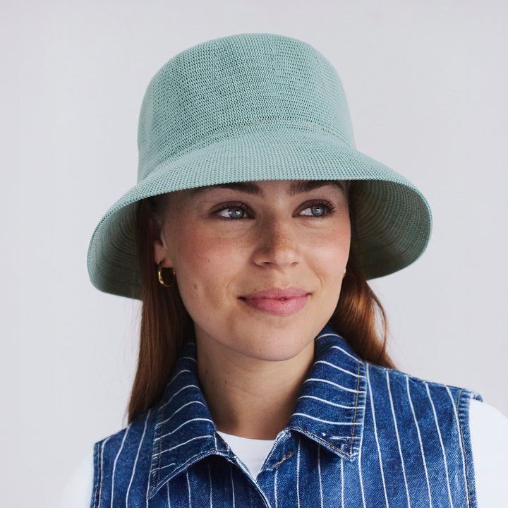 Female model wearing Tamzin Bucket Hat in blue haze colour, front view styled with casual outfit