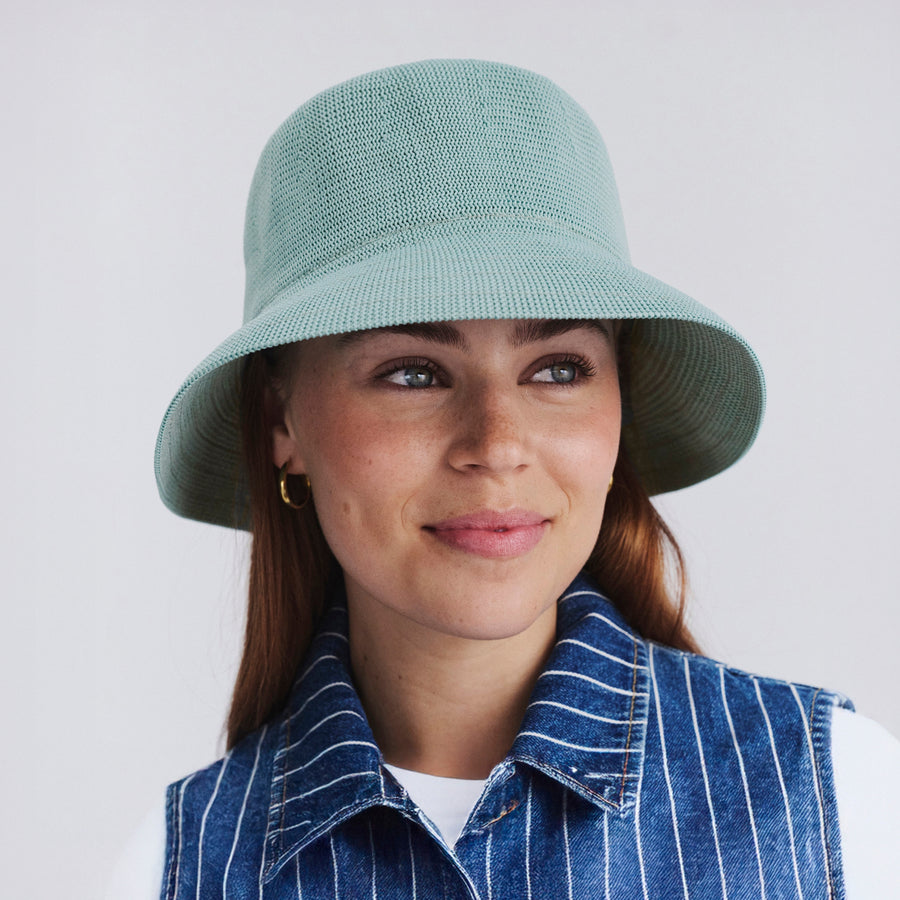 Female model wearing Tamzin Bucket Hat in blue haze colour, front view styled with casual outfit