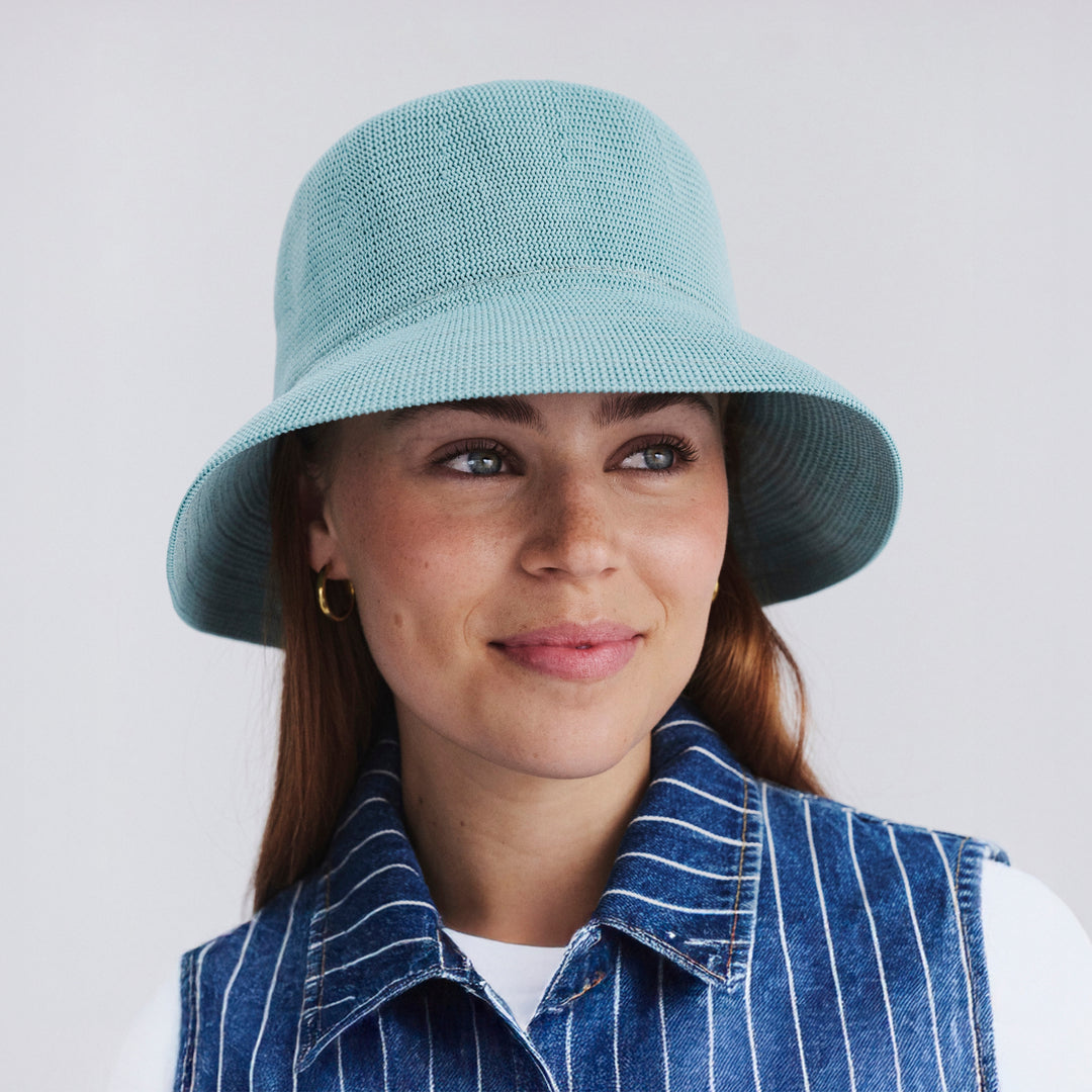 Female model wearing Tamzin Bucket Hat in blue haze colour, front view styled with casual outfit