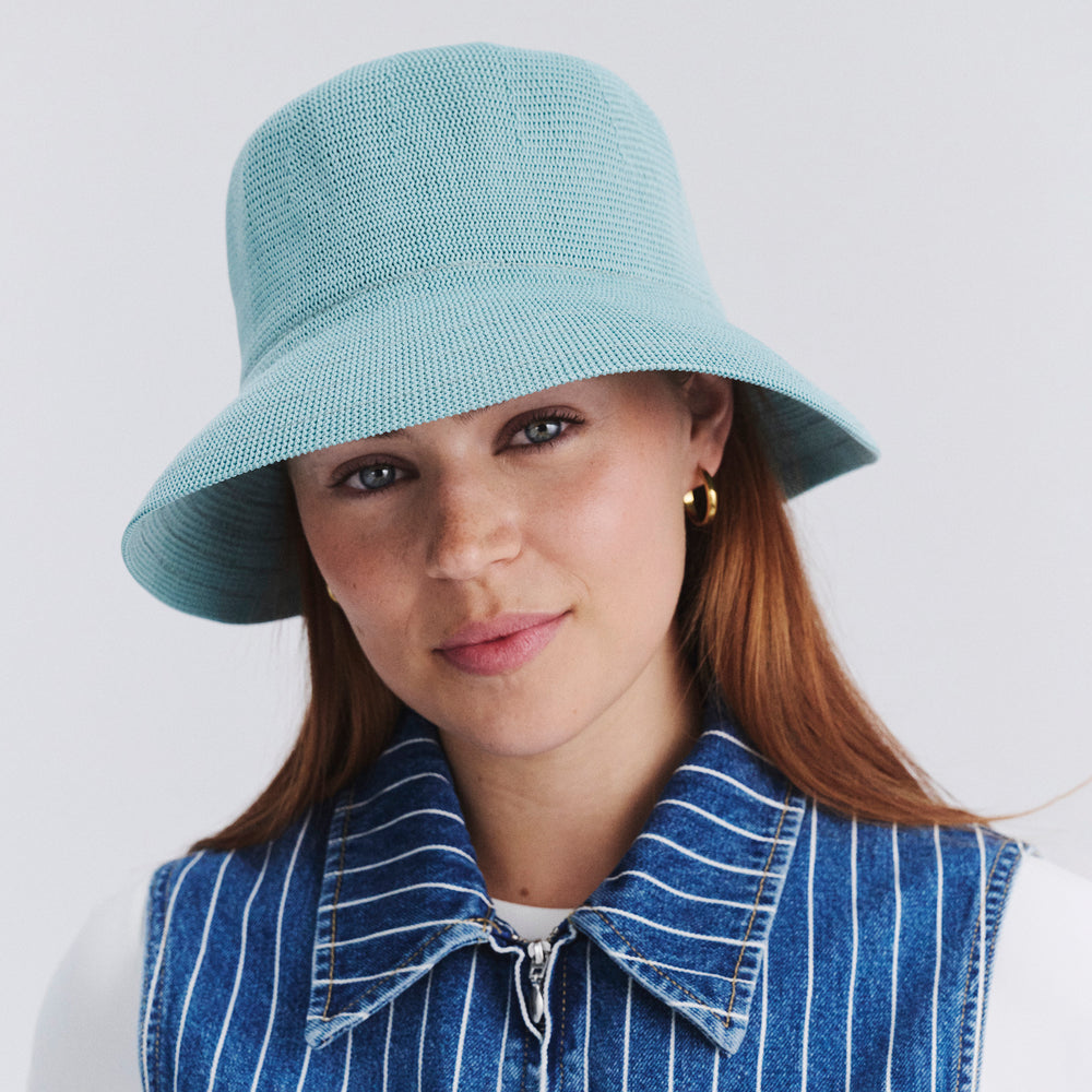 Female model wearing Tamzin Bucket Hat in blue haze colour, front view styled with casual outfit