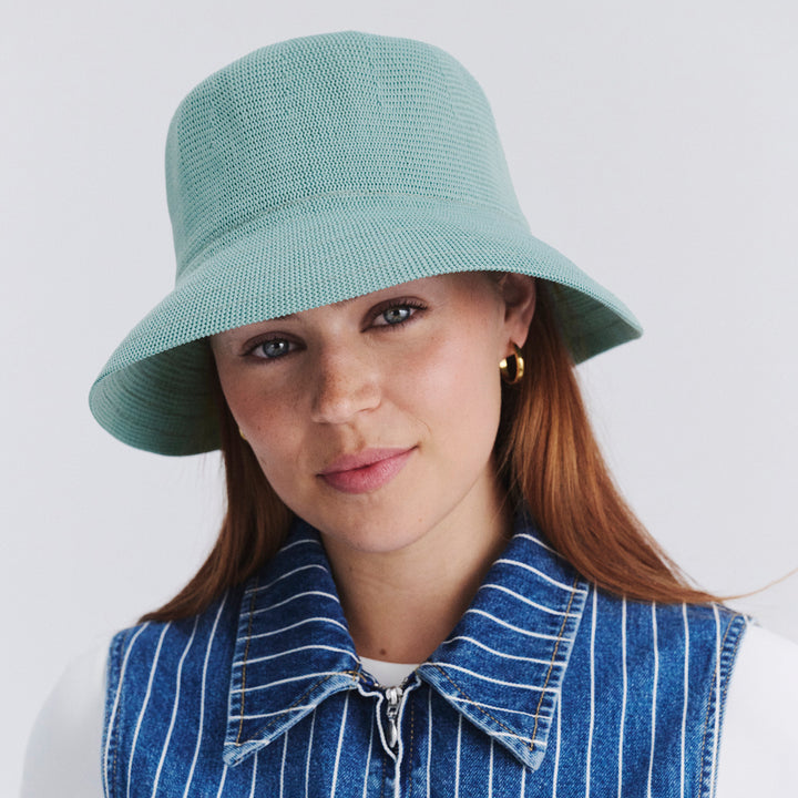 Female model wearing Tamzin Bucket Hat in blue haze colour, front view styled with casual outfit